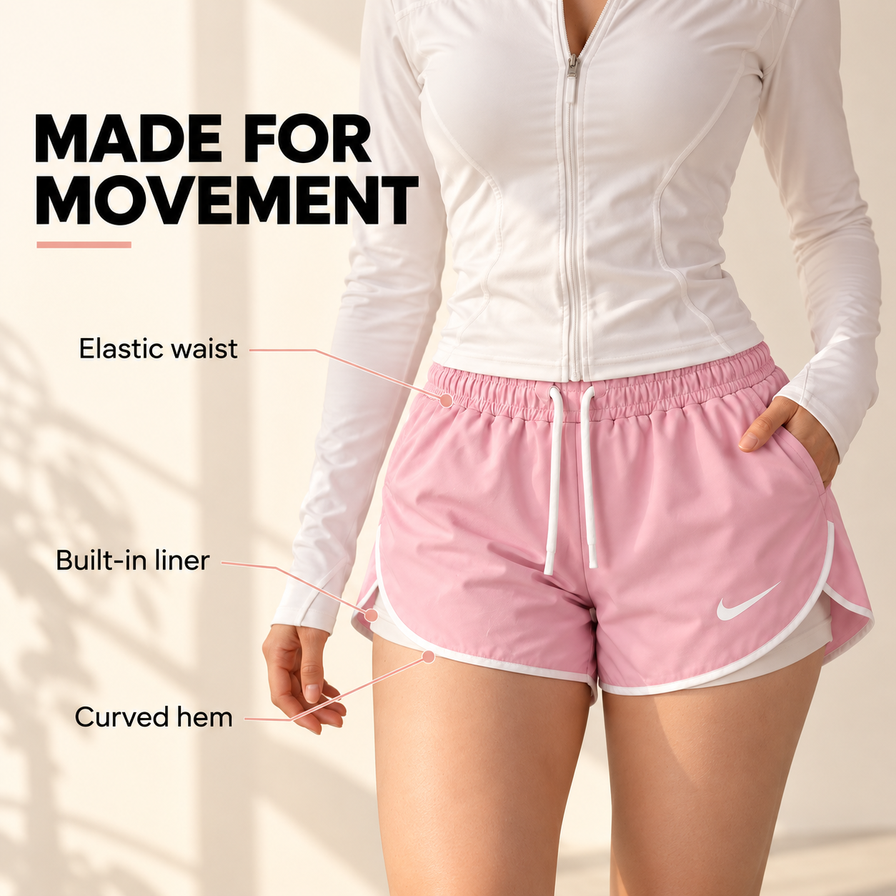 Pink shorts showing the elastic waist, built-in liner, and curved hem
